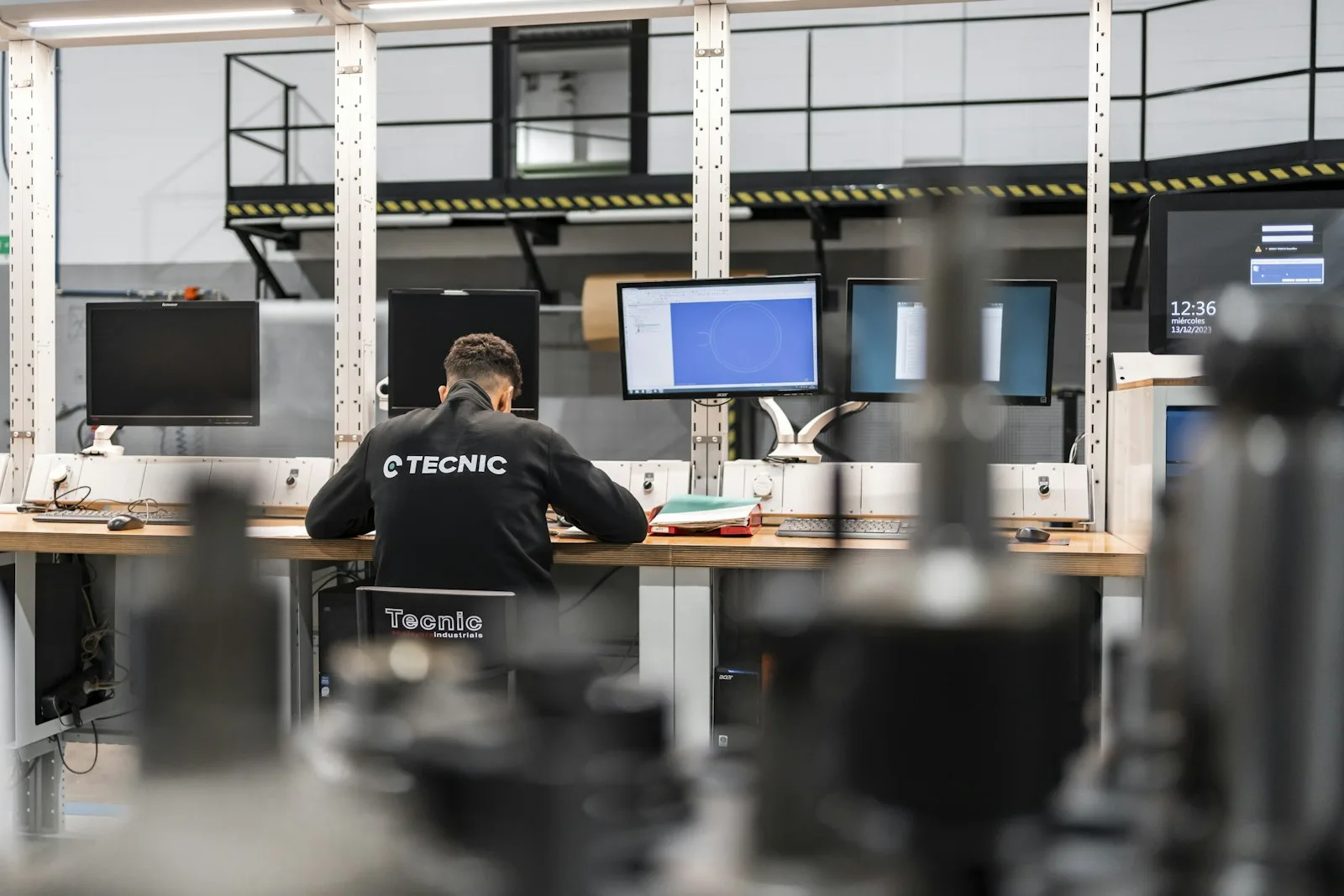 Engineer working at a multi-screen CAD workstation
