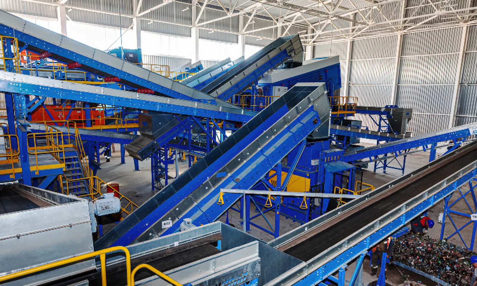 Picking line at a materials recovery facility, inclined belts feeding sorters